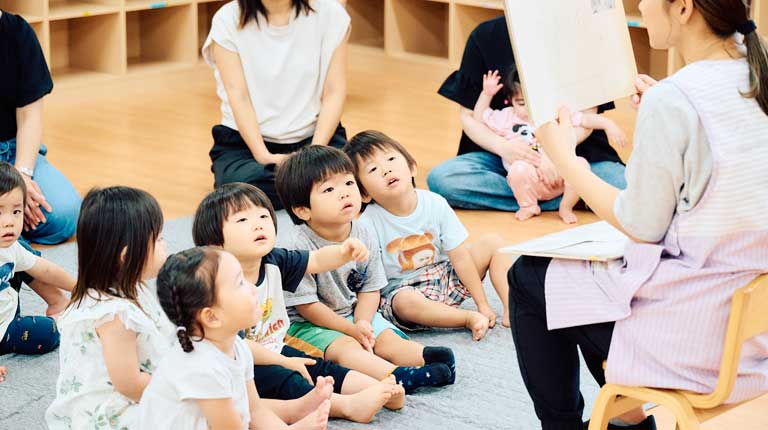 先生と一緒に園で過ごす子どもたち